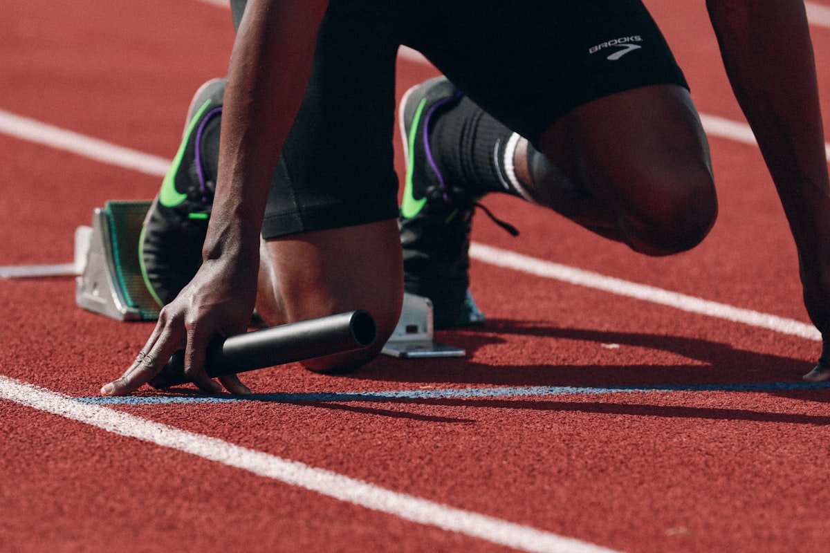 Athlete in starting position on a running track